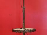a table with a lamp on top of it in front of a red wall