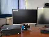 un bureau sur lequel sont posés deux écrans et un ordinateur portable