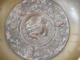 a metal plate with a picture of a woman on it