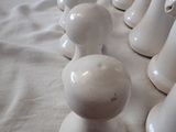 a lot of white vases sitting on a table