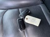 a picture of a car seat with a key and a note attached to it