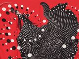 a red scarf with black and white polka dots on it