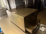 stainless steel counter top in a commercial kitchen with stainless steel appliances