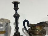 two silver vases and a silver teapot sitting on a table
