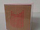 packaging of a box with red dots on it on a white surface