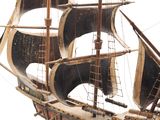a wooden model of a ship on display on a stand