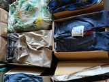 many boxes of clothes that are stacked on top of each other