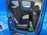 a blue van that has two seats in it
