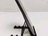 a cell phone sitting on a stand on a table