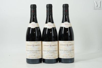 trois bouteilles de vin posées sur une table blanche
