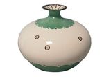 a green and white vase with a flower on it