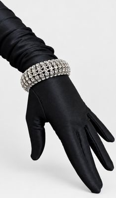 a close up of a person wearing black gloves and a bracelet