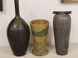 three vases sitting next to each other on a table