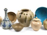 un ensemble de vases et de bols posés sur une surface blanche