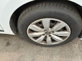 a close up of a tire on a white car
