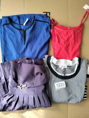 three shirts and a skirt on a cardboard box with a price tag