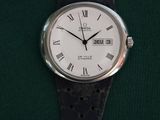 a close up of a watch with roman numerals on it