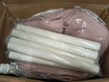 a cardboard box with a bunch of white candles inside of it