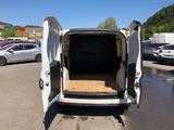 the back of a white van with its doors open in a parking lot
