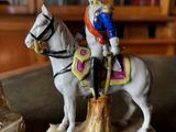 a figurine of a man riding a horse on a table