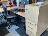 a desk with a file cabinet and a chair in front of it