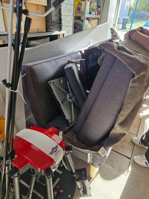 a pile of luggage and skis sitting in a garage