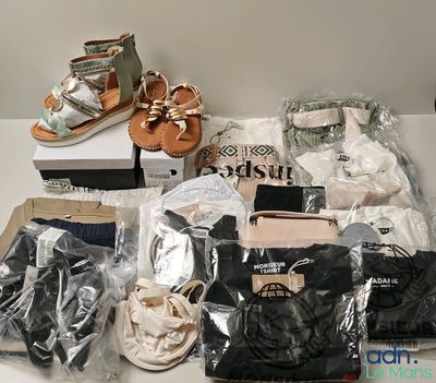 several pairs of sandals are sitting on a table next to a pair of shoes