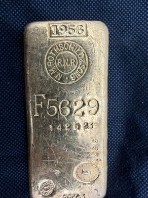 un lingot d'argent posé sur un tissu bleu