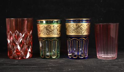several different colored glasses are lined up on a black surface