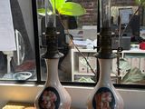 two vases that have plants in them on a table