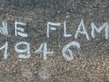 the name of a stone is etched into the ground