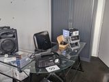 a glass table with speakers on it in a room