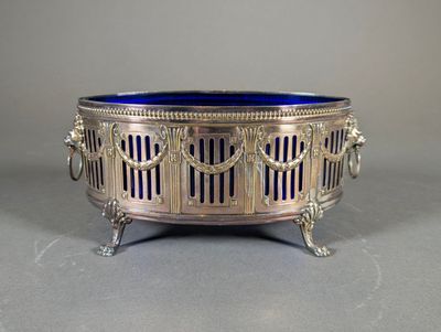 an antique silver and blue glass bowl on a stand