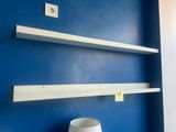 a lamp that is sitting on a shelf next to a blue wall