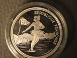 a close up of a silver coin with a woman on it