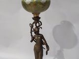 bronze and green vase with a woman holding a flower on it