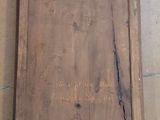 a picture of a wooden frame with a sign on it
