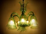 a green glass chandelier hanging from the ceiling