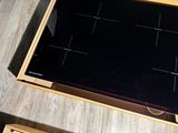 a wooden box with a black stove top on a wooden table