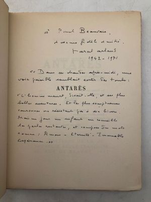 an open book with a handwritten text on it sitting on a table