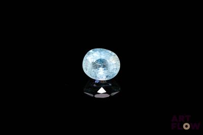 a close up of a blue diamond on a black surface
