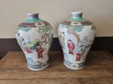 two vases that are sitting on a wooden table