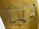 an image of a close up of a yellow skirt with a pocket