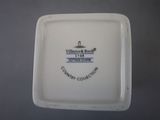 a white plate with a black and white logo on it