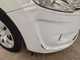 a close up of a car with a denting on the front of it
