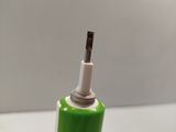 a green and white toothbrush sitting on a white table