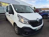 the white van is parked in front of a building in a parking lot