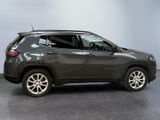 the jeep compass is parked in a room with a gray wall