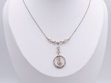 a close up of a necklace on a mannequin with a white background