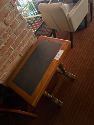 two chairs and a table in a room with a brick wall